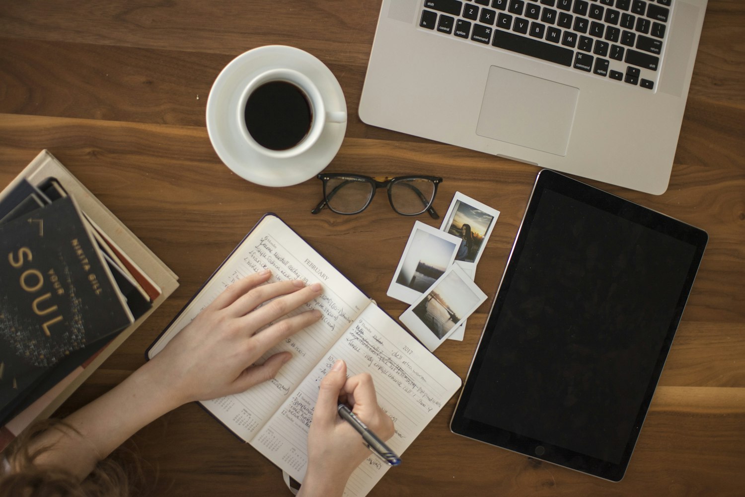 A journal, coffee and tablet laid out for a calm morning of reflection